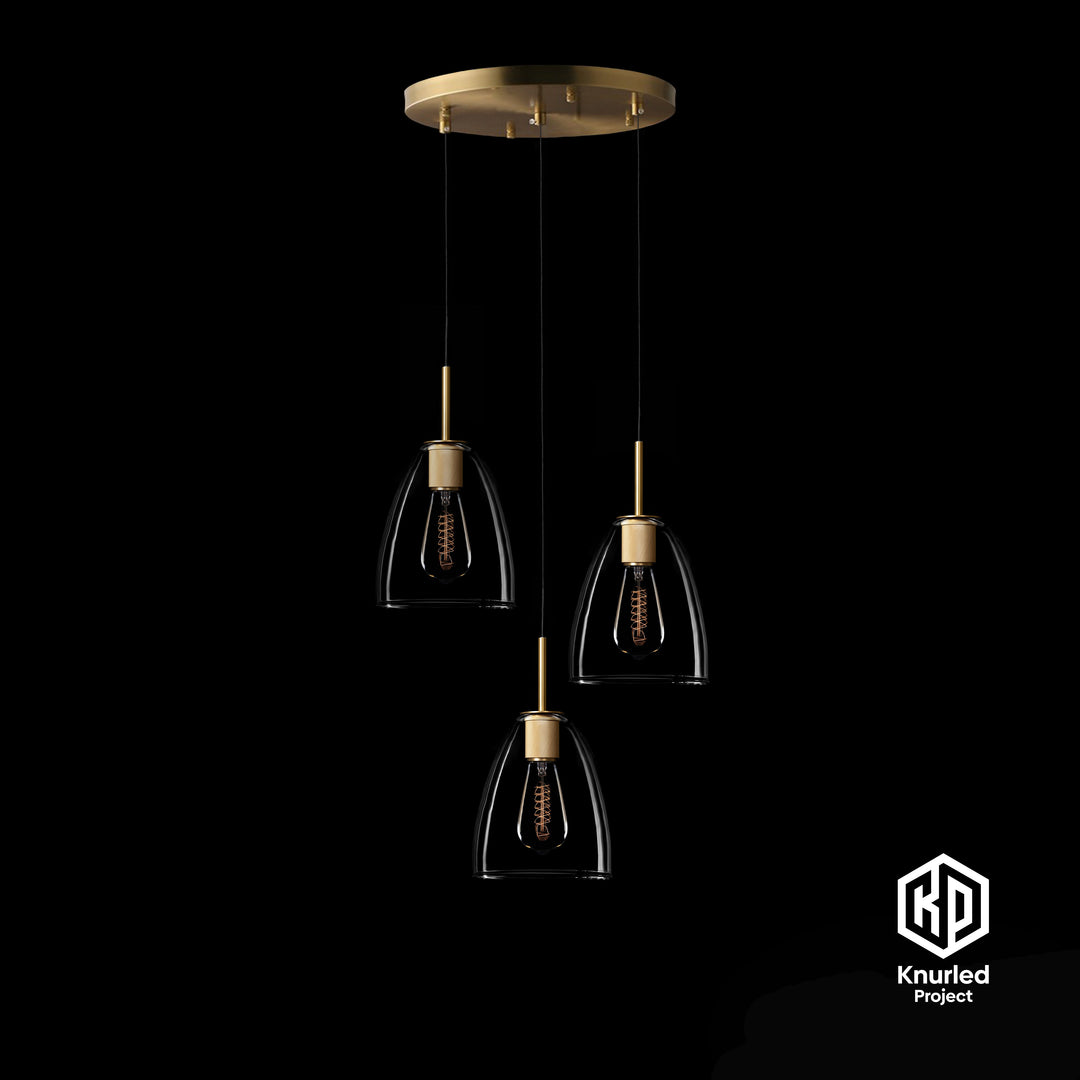 A brass chandelier with three pendant lights and bell shaped light shades