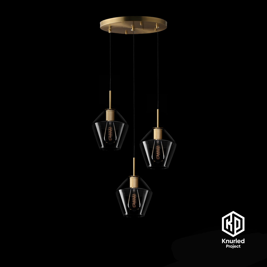 A brass chandelier with three pendant lights and diamond shape light shades