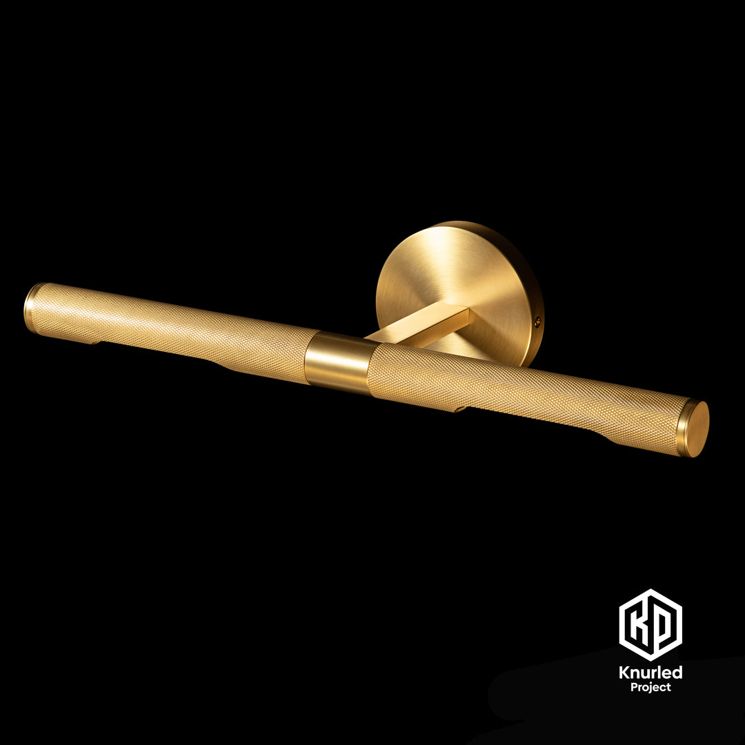 Brass knurled picture wall light with diamond cut at an angle on black background