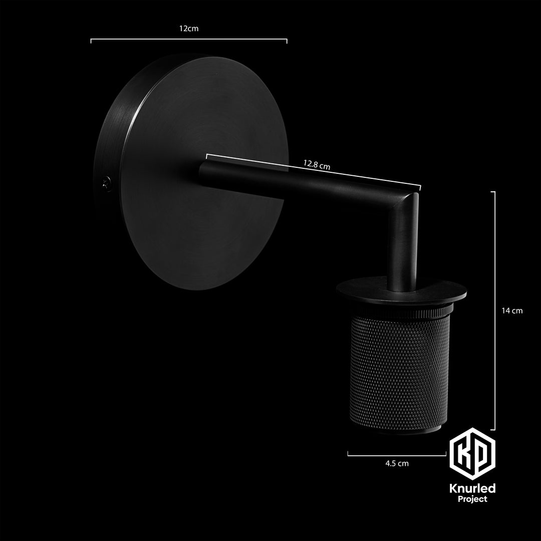 Matte black brass wall light at an angle with product measurements