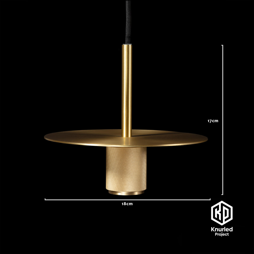 Brass pendant light hanging from a light chord with product measurements