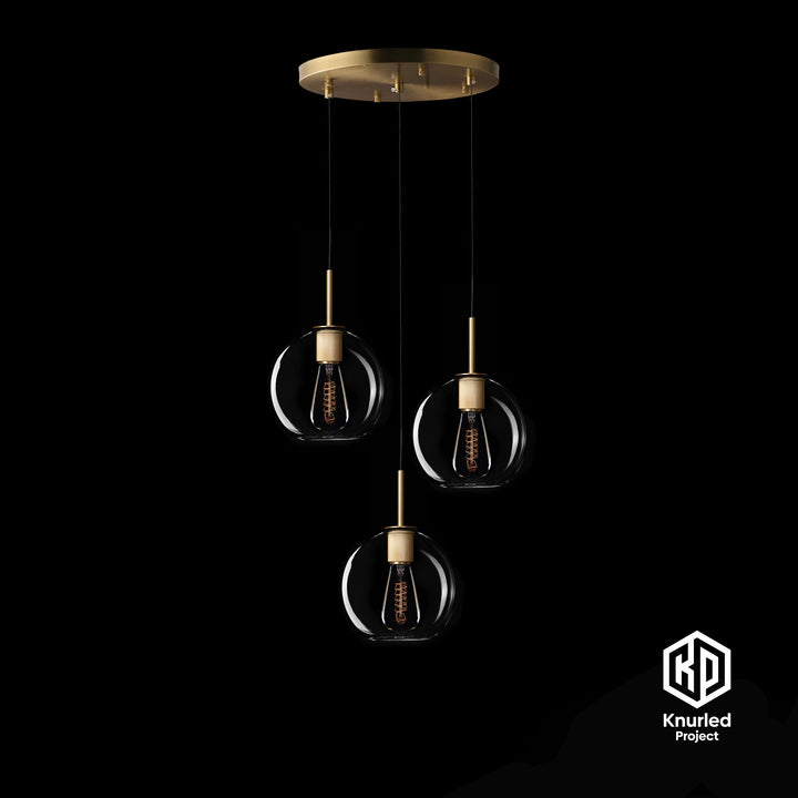 A brass chandelier with three pendant lights and globe shape light shades