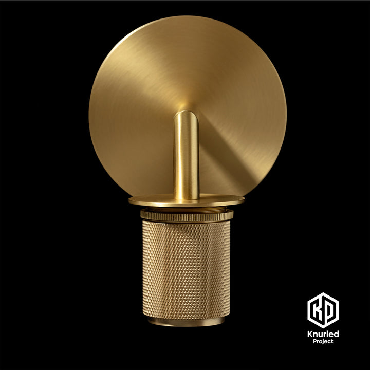 Brass wall light front on to show diamond cut and knurled finish  on a black background