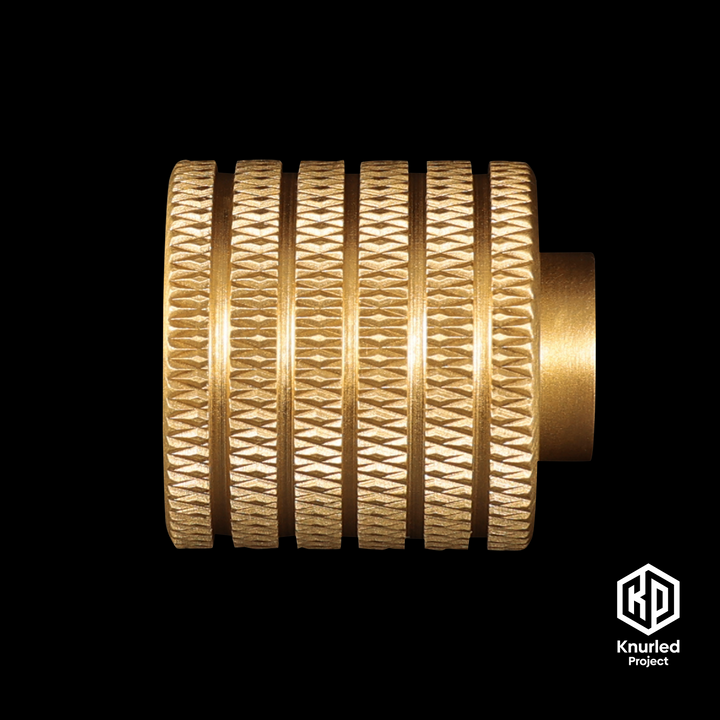 Brass button handle by The Knurled Project on a black background