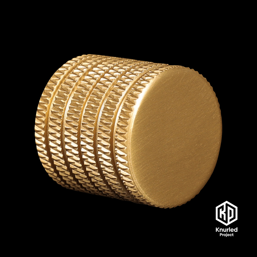 Brass button handle by The Knurled Project on a black background