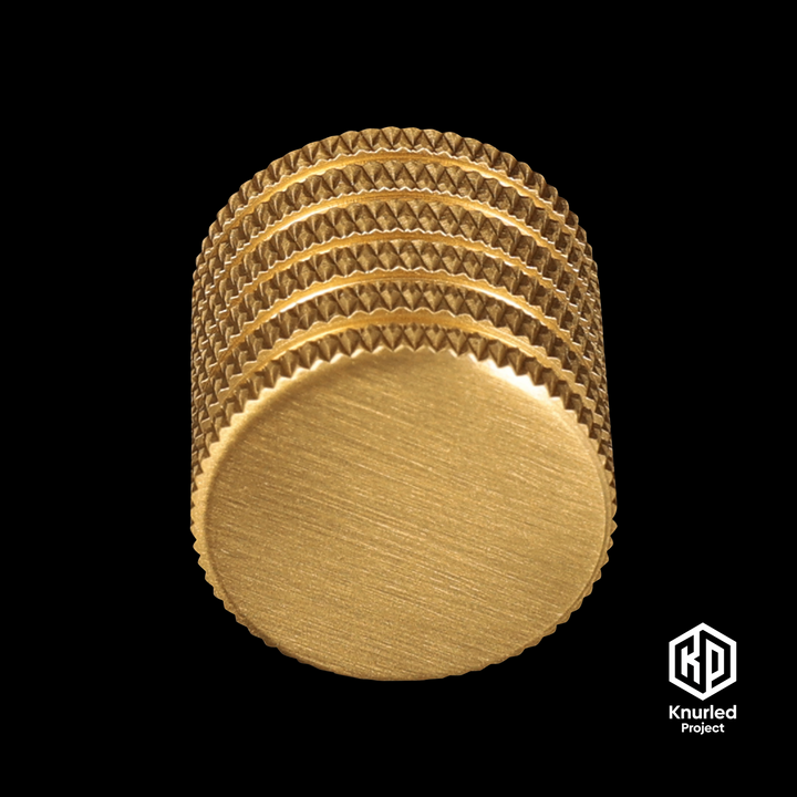 Brass button handle by The Knurled Project on a black background