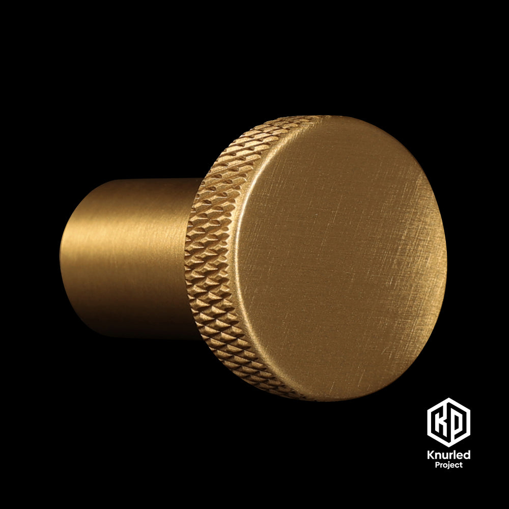 Brass mushroom button handle on a black background