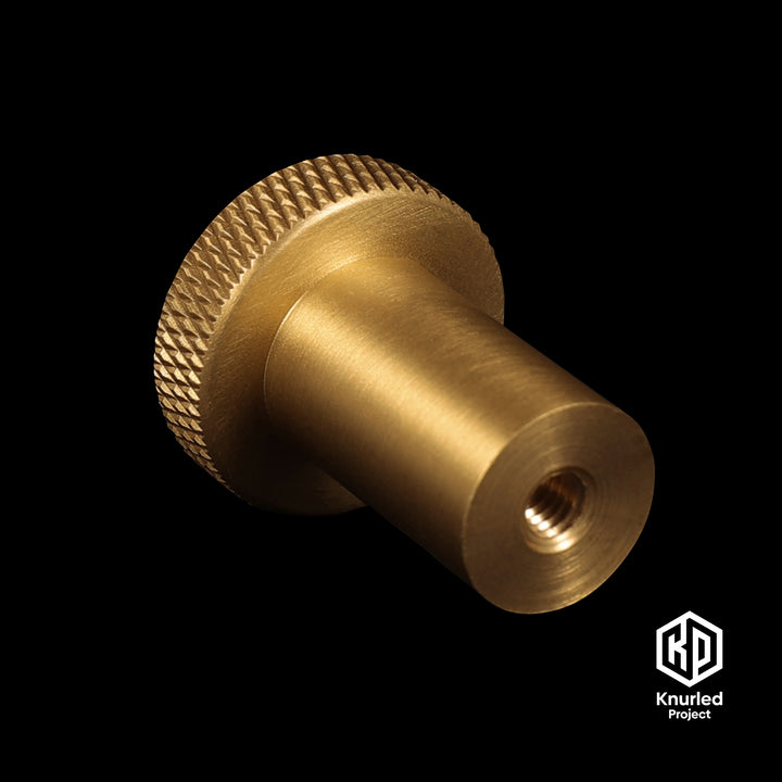 Brass mushroom knob on a black background