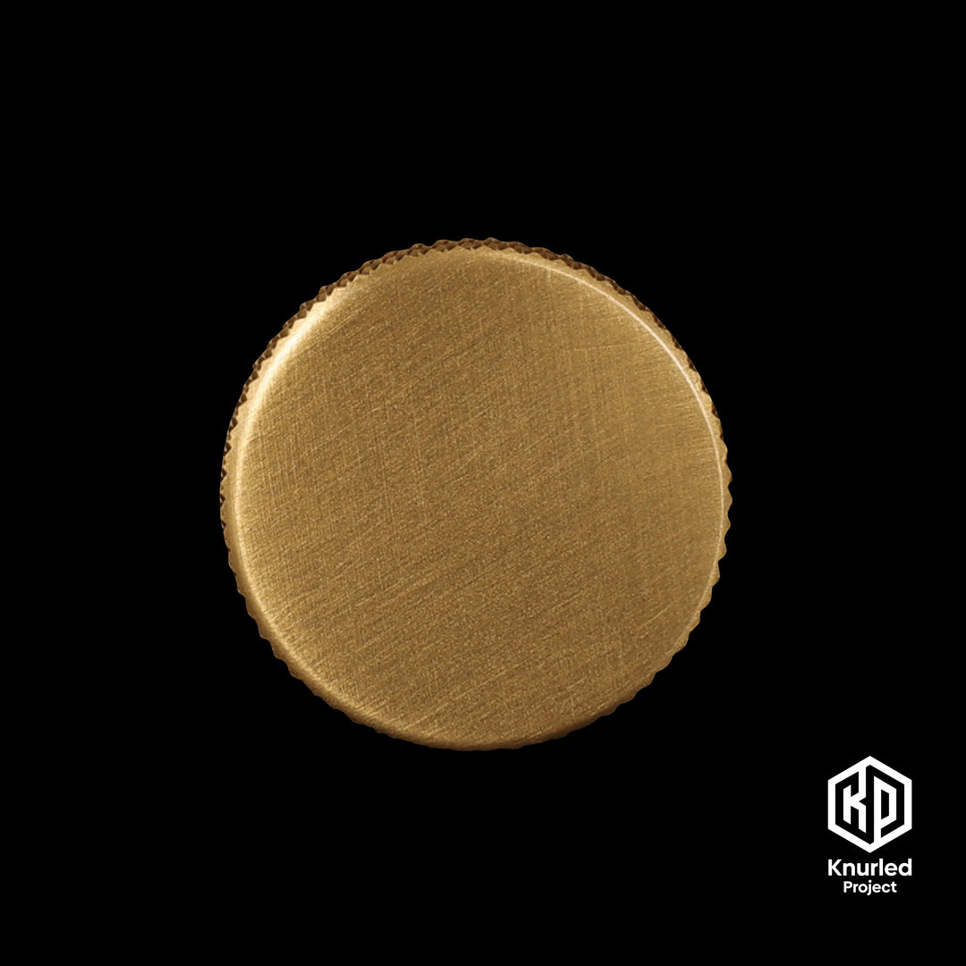 Brass mushroom button handle on a black background