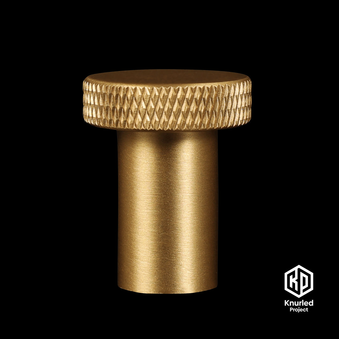 Brass mushroom button handle on a black background