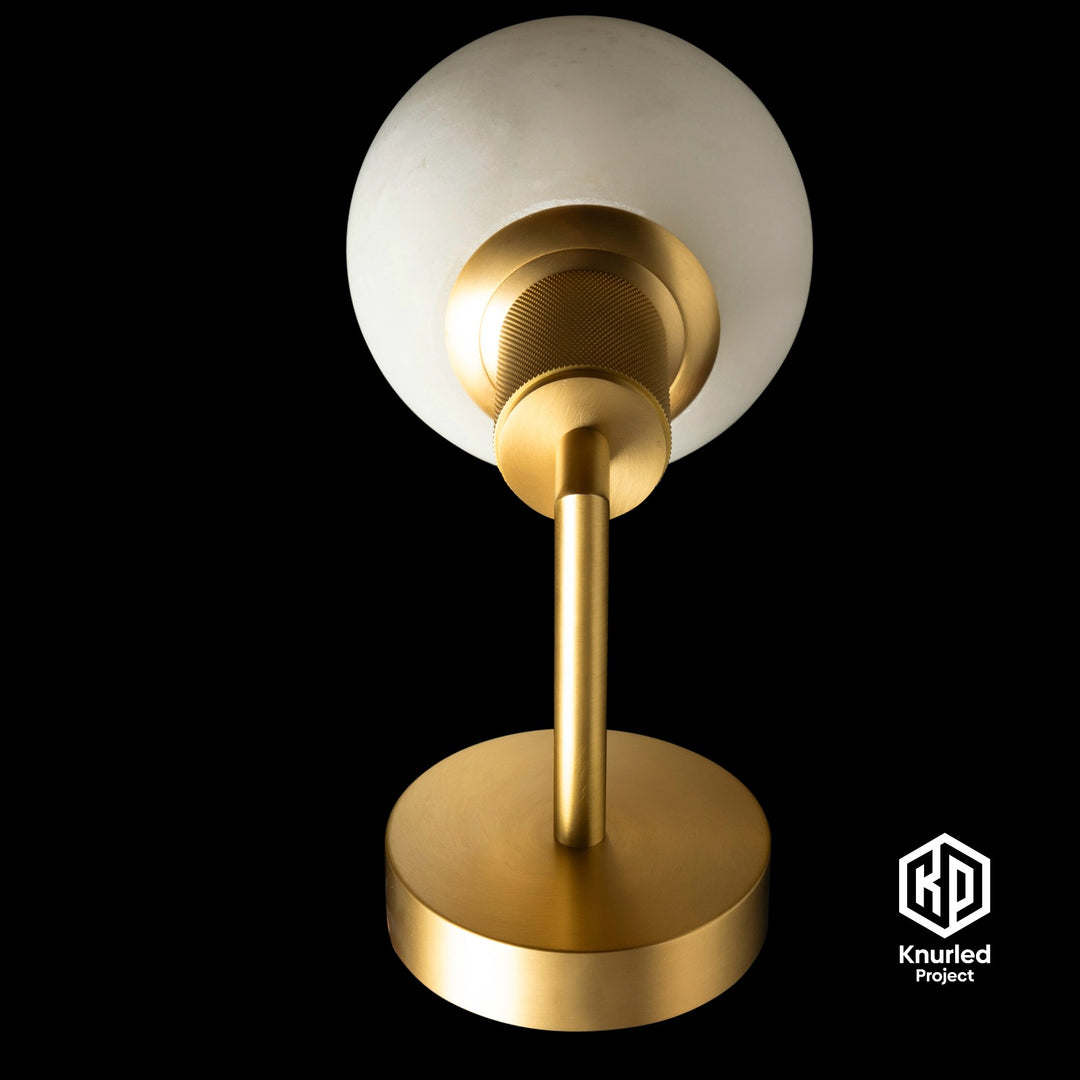 Marble brass sconce light on black background