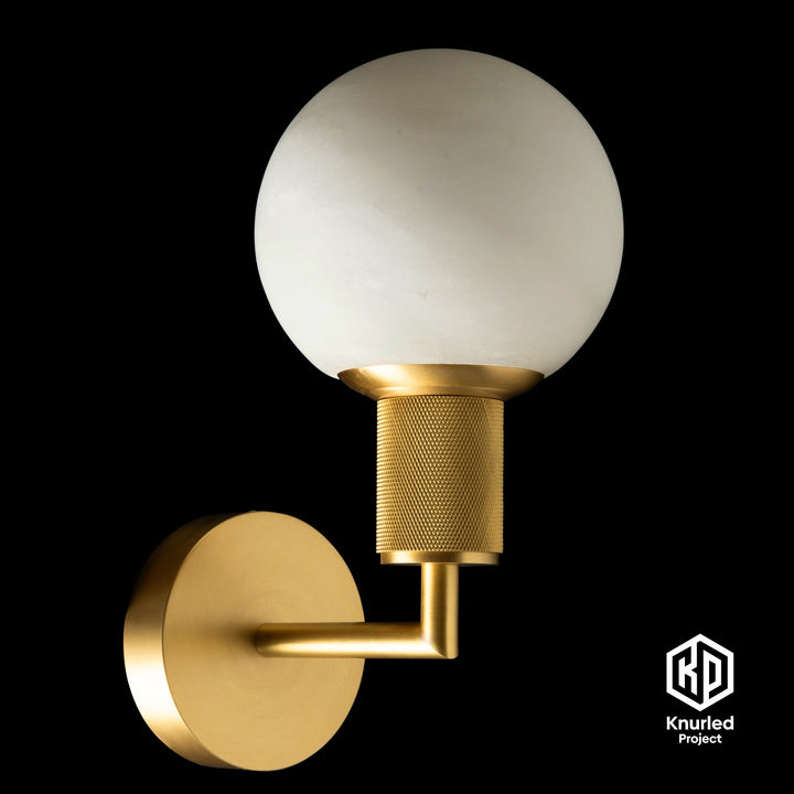 Marble brass sconce light on black background