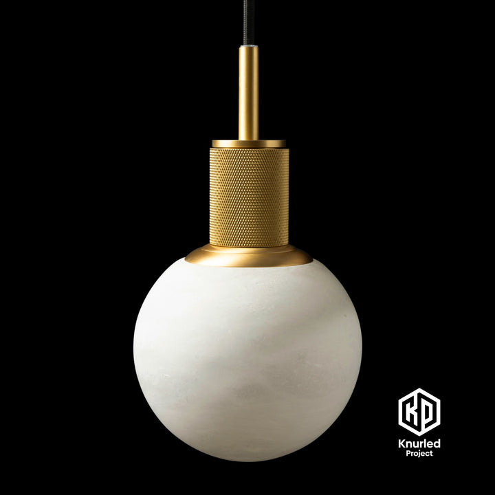 Marble brass pendant light hanging from ceiling