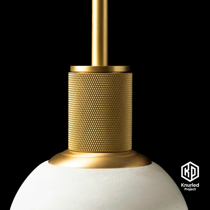 Marble brass pendant light hanging from ceiling