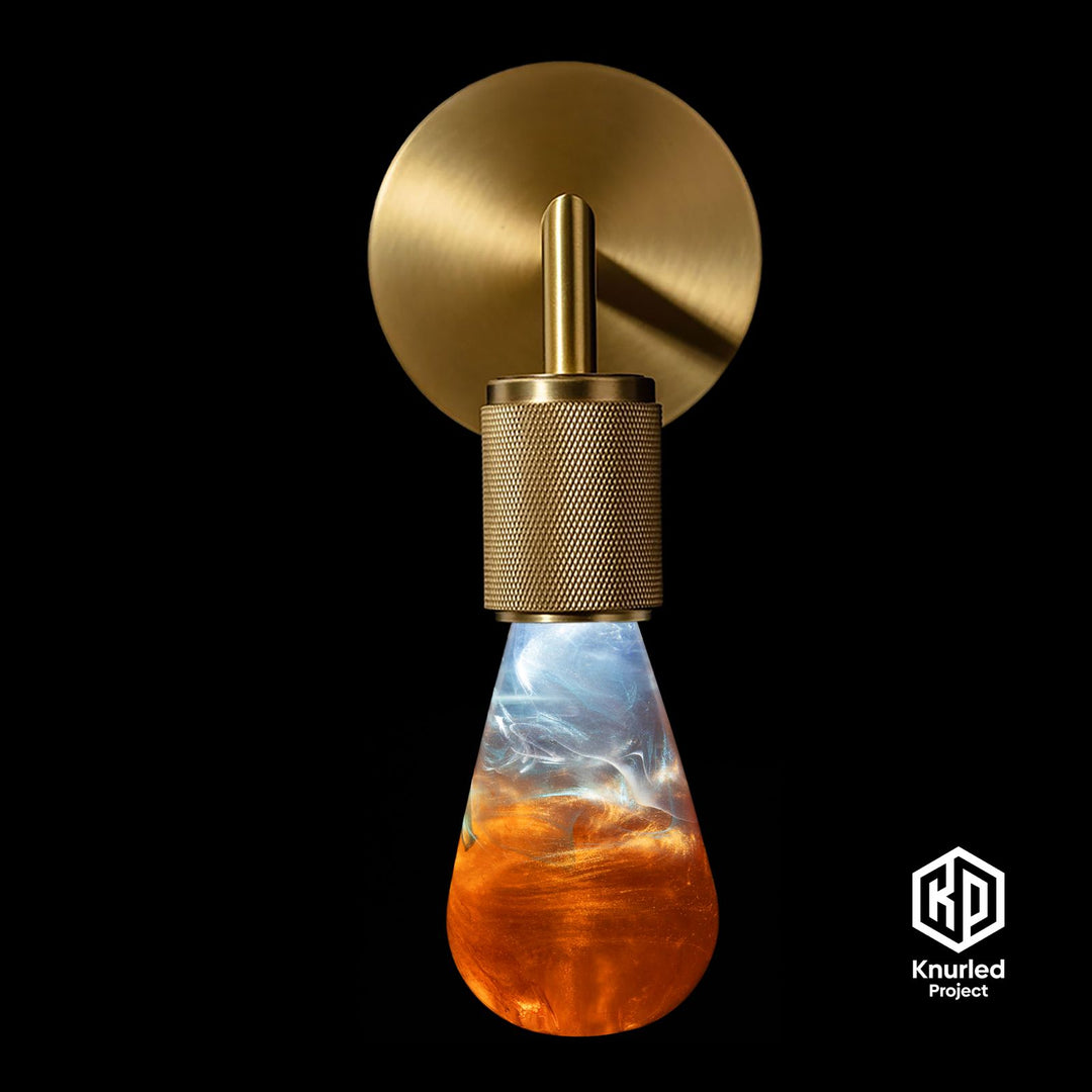 Orange lava mood bulb with brass wall light