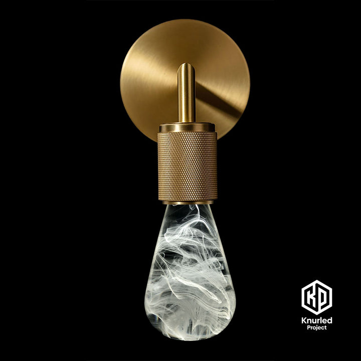 White smoked lava mood bulb in a brass wall light