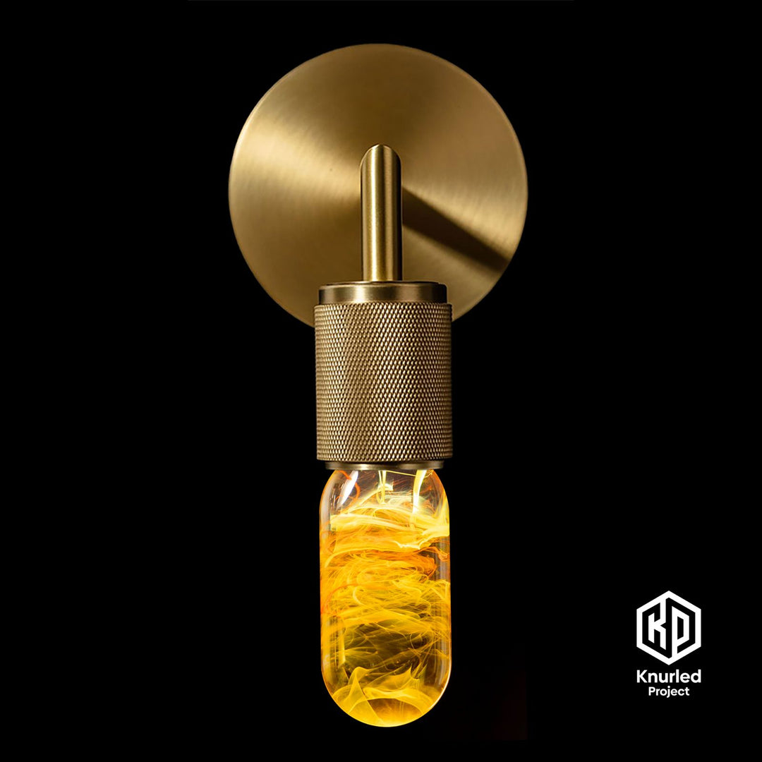 Yellow lava mood bulb in a brass wall loght