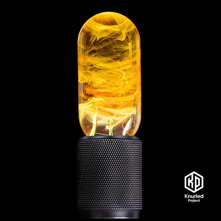 Yellow lava mood bulb in a matte black holder